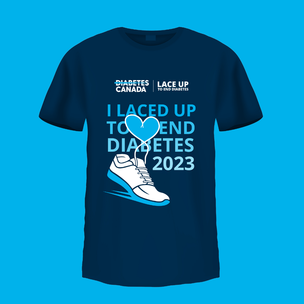 A dark blue t-shirt with the Diabetes Canada and Lace Up logos on it. The t-shirt has an illustration of a running shoe with the laces forming a heart. The text on it states "I laced up to end diabetes 2023". The shirt is on a light blue background.
