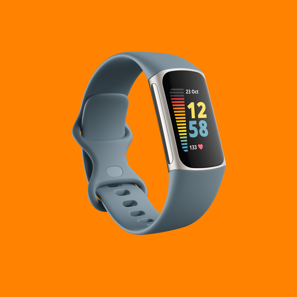 A Fitbit Charge 5 on an orange background.